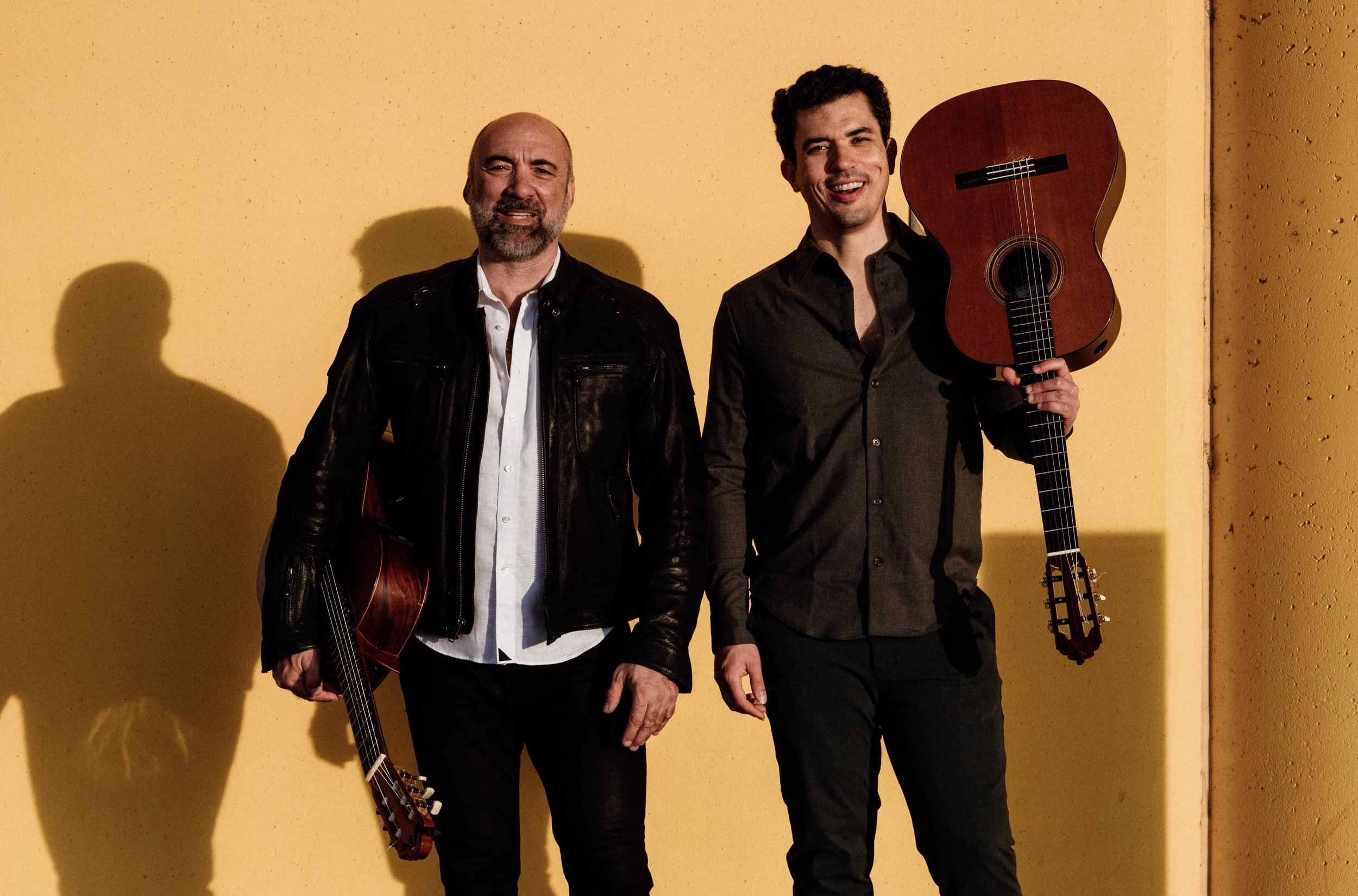 Petar & Daniel — duo portrait against a warm yellow wall